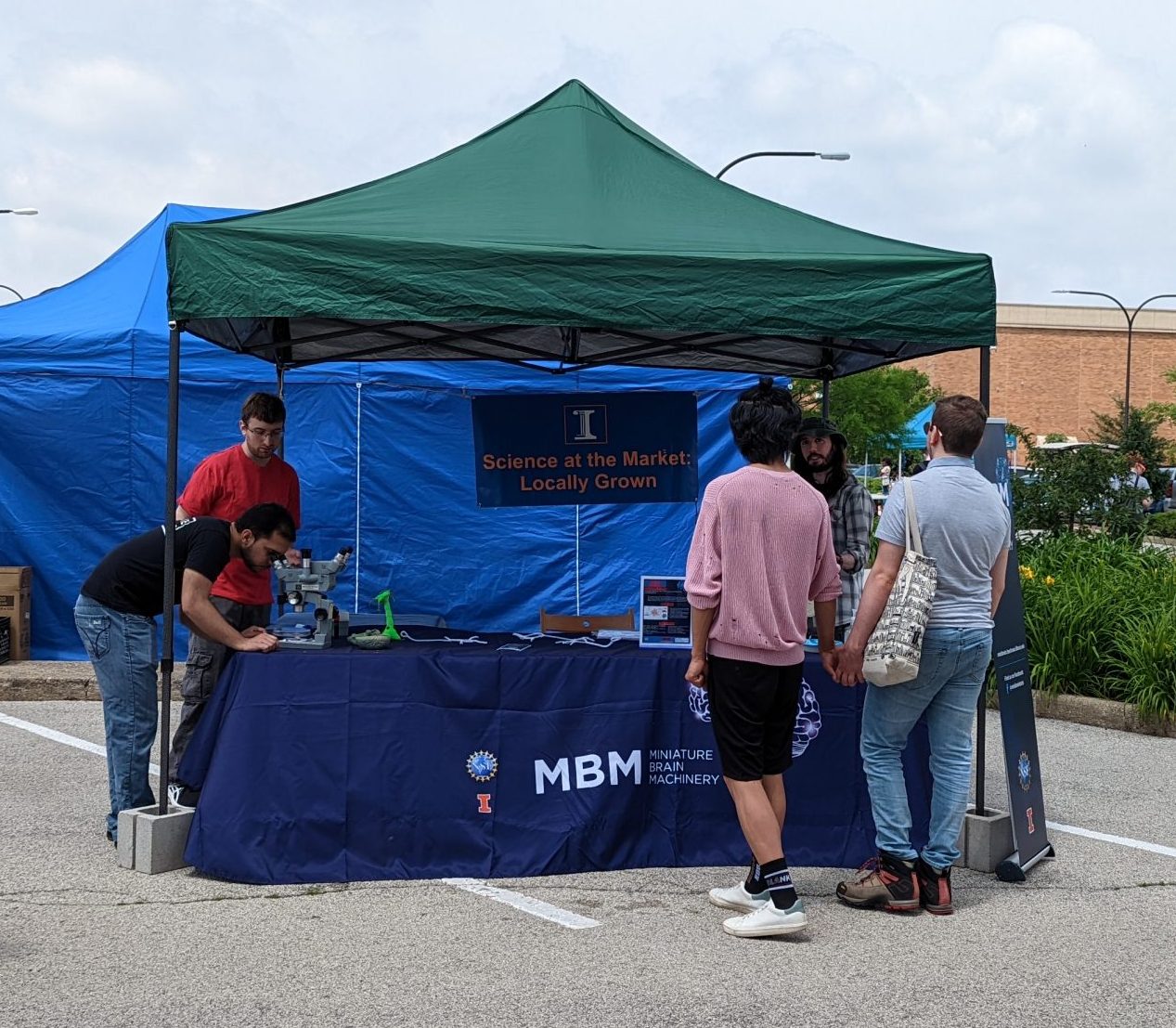 MBM trainees interact with farmer's market attendees
